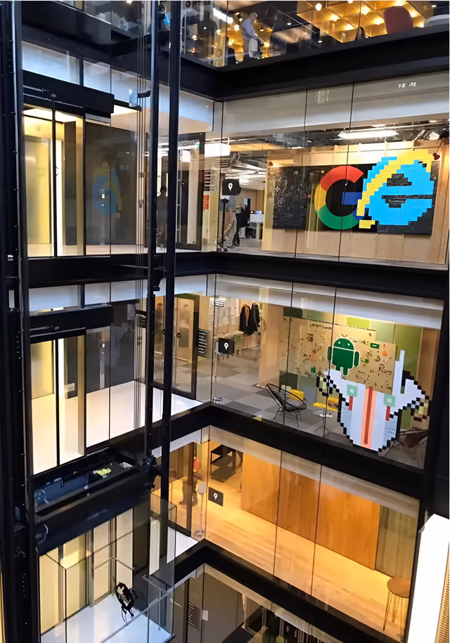 Google office atrium with glass lifts