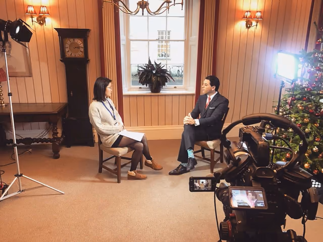 Interview being filmed in a panelled room