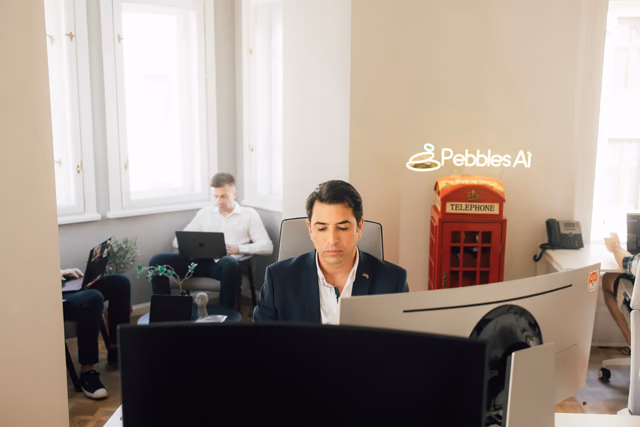 The Pebbles Ai office with its neon sign and telephone box